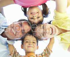 Family Group Looking Down Into Camera