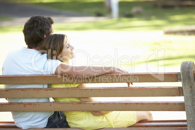 Couple Sitting Together On Park Bench