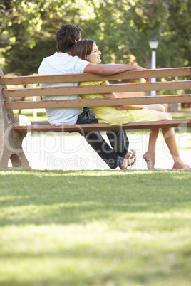 Couple Sitting Together On Park Bench