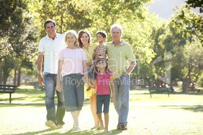 Extended Group Portrait Of Family Enjoying Walk In Park