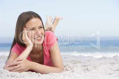 Frau liegt am Strand