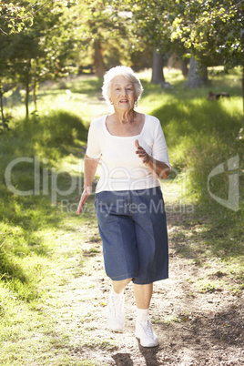 Senior Woman Jogging In Park