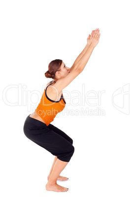 Woman Practicing Yoga Exercise Called Chair Pose