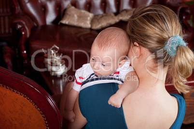 Mother Holding Baby in Living Room