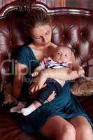 Mother with Her Baby on Sofa