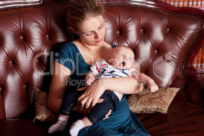 Mother with Her Yawning Baby on Sofa