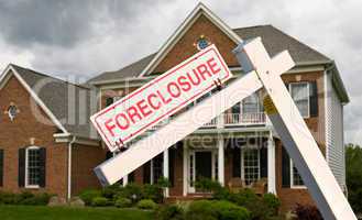 Foreclosure sign in front on modern house