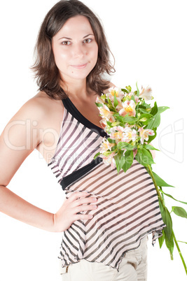 Portrait of pretty pregnant woman with flowers