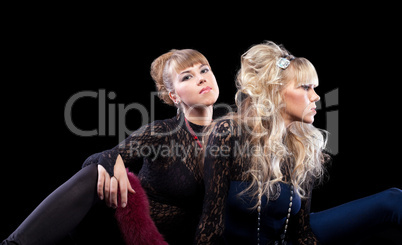 Two pretty sisters posing in lace costume