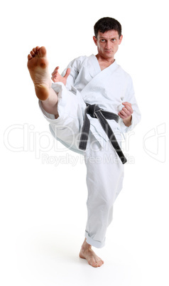 Karate. Man in a kimono hits foot