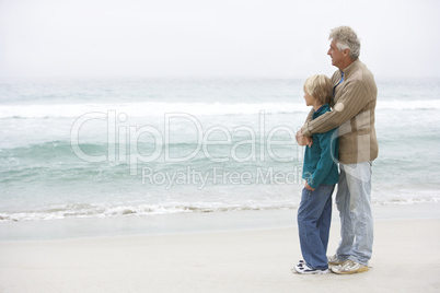 Grandfather And Son Standing On Winter Beach Together