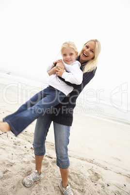 Mother And Daughter On Holiday Having Fun On Winter Beach