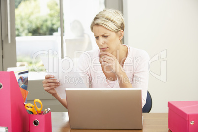 Woman Using Laptop At Home