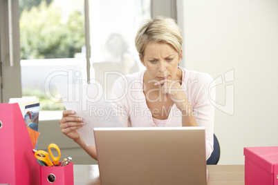 Woman Using Laptop At Home