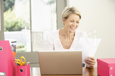 Woman Using Laptop At Home