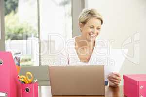 Woman Using Laptop At Home