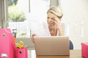 Woman Using Laptop At Home