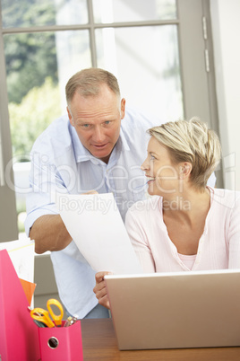 Couple Using Laptop At Home