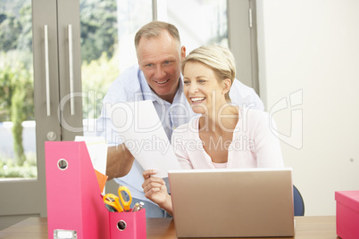 Couple Using Laptop At Home