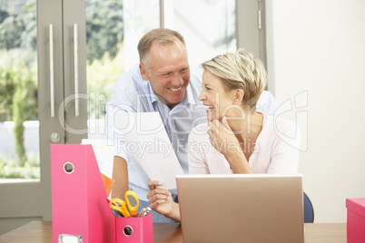 Couple Using Laptop At Home