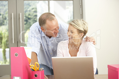 Couple Using Laptop At Home Couple Using Laptop At Home