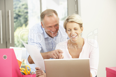 Couple Using Laptop At Home