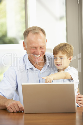 Father And Son Using Laptop At Home