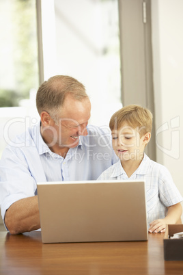 Father And Son Using Laptop At Home