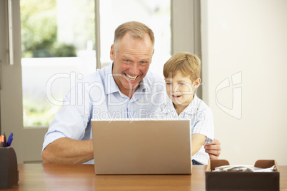 Father And Son Using Laptop At Home