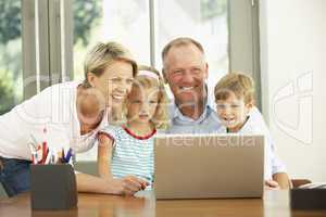 Family Using Laptop At Home