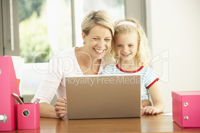 Mother And Daughter Using Laptop At Home