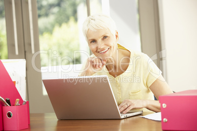 Senior Woman Using Laptop At Home