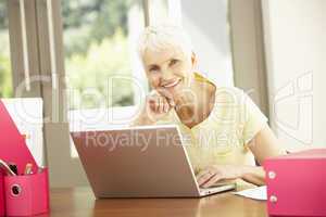 Senior Woman Using Laptop At Home