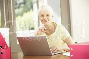 Senior Woman Using Laptop At Home