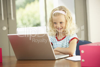 Young Girl Using Laptop At Home