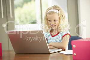 Young Girl Using Laptop At Home