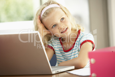 Young Girl Using Laptop At Home