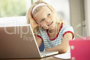 Young Girl Using Laptop At Home