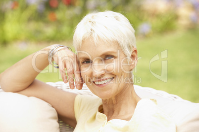 Senior Woman Relaxing In Garden