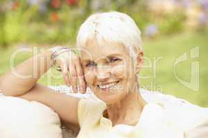 Senior Woman Relaxing In Garden