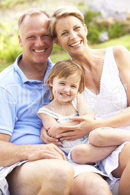 Family Relaxing In Garden