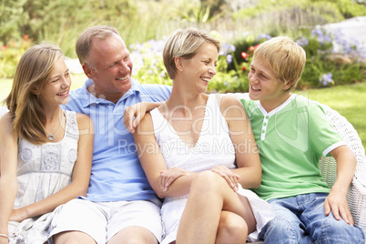 Family Relaxing In Garden