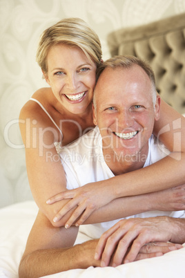 Couple Relaxing In Bedroom