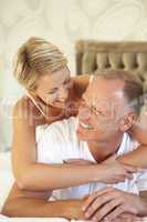 Couple Relaxing In Bedroom