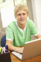 Teenage Boy Using Laptop At Home