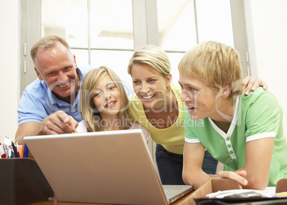 Family Using Laptop At Home