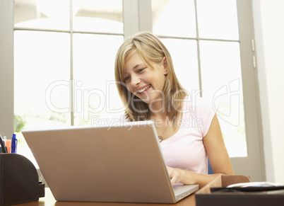 Teenage Girl Using Laptop At Home