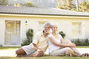 Senior Couple sitting Outside Dream Home