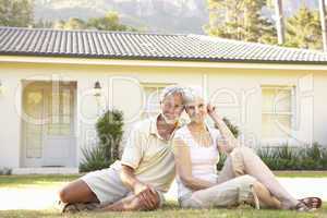 Senior Couple sitting Outside Dream Home