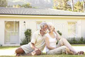 Senior Couple sitting Outside Dream Home